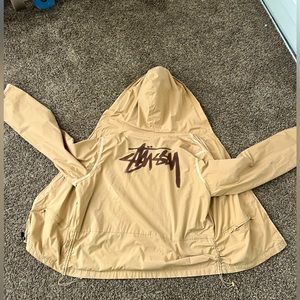 Beige colored hiking Stussy jacket